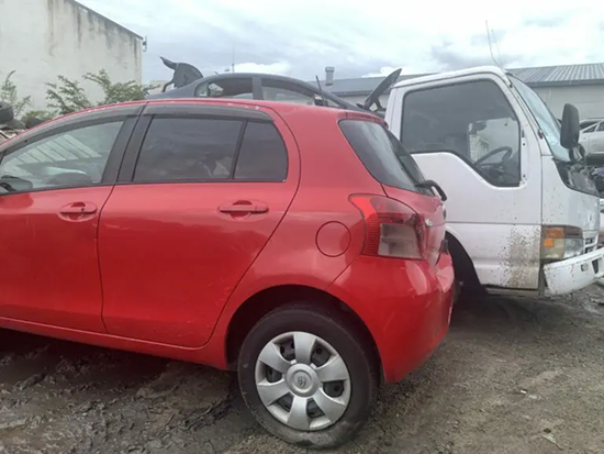 Tow truck transporting three scrap cars for removal in 0800 Car Salvage